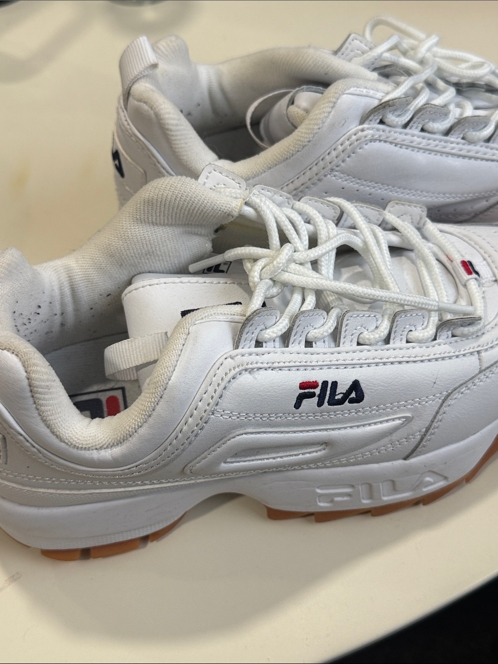Fila white sneakers with red and navy logo accents